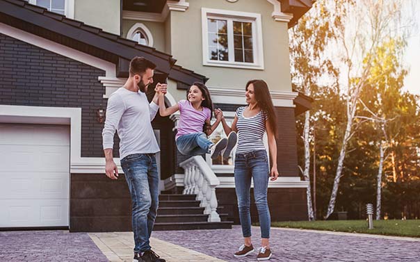 family in front of house